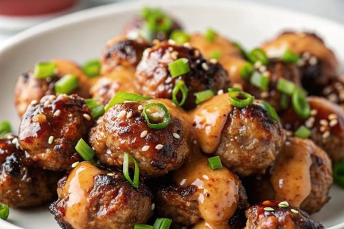 Korean BBQ Meatballs with Spicy Mayo Dip Korean BBQ Meatballs with Spicy Mayo Dip Korean BBQ meatballs with spicy mayo dip, plated with garnishes.